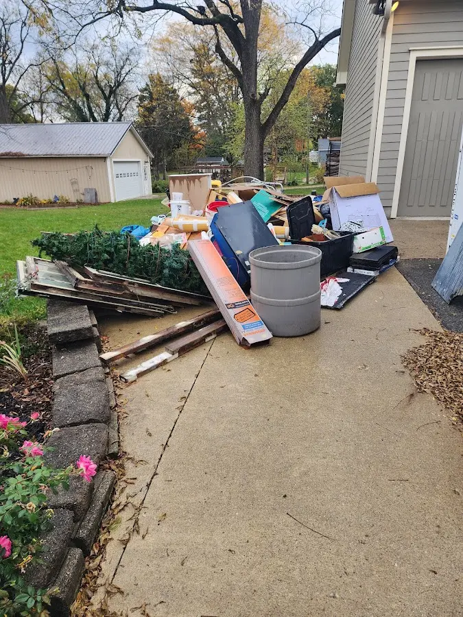 Dumpster being loaded with debris for 10 Yard Dumpster Rental in Burlington